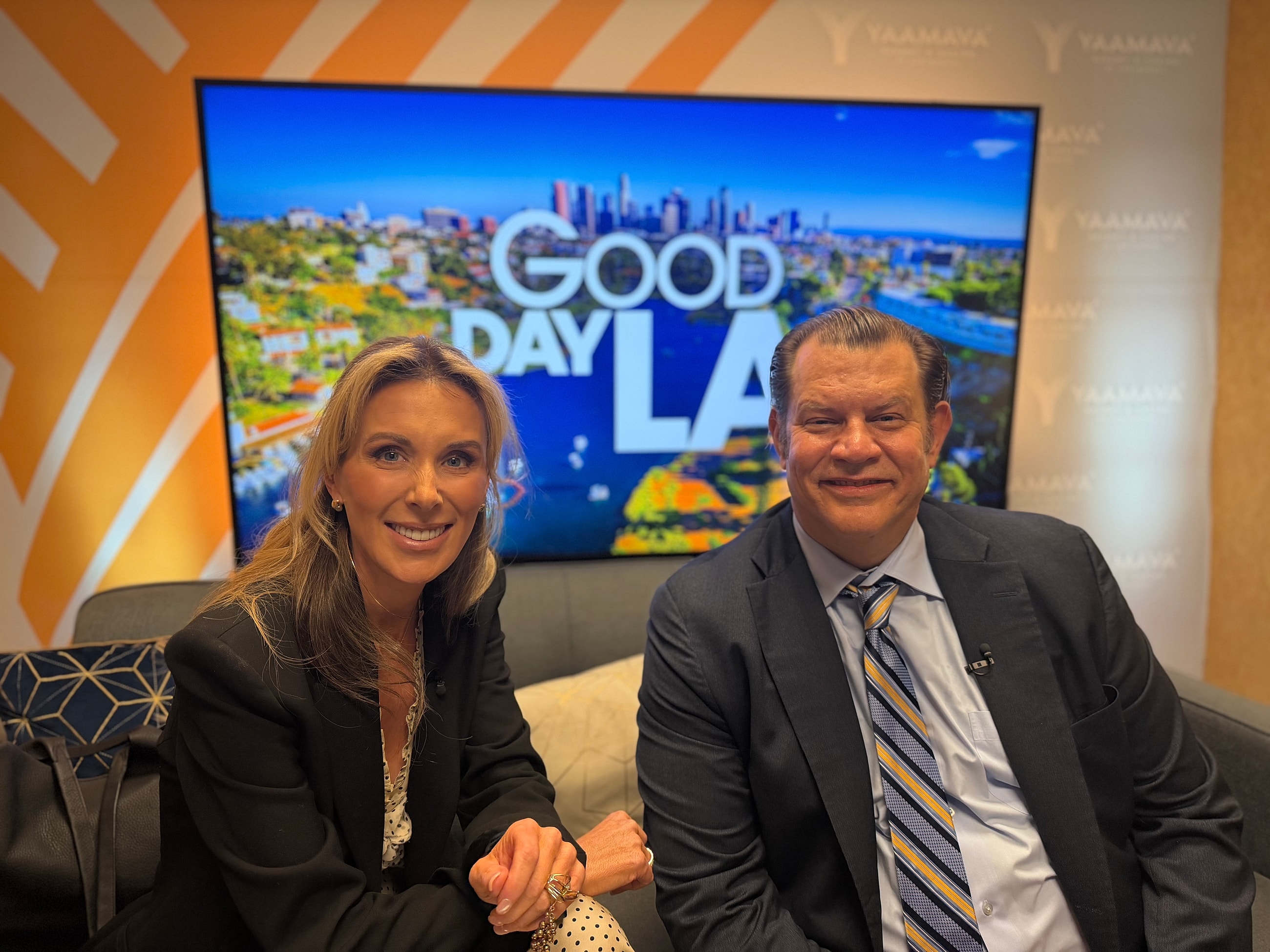 Hosts smiling on set of Good Day LA.