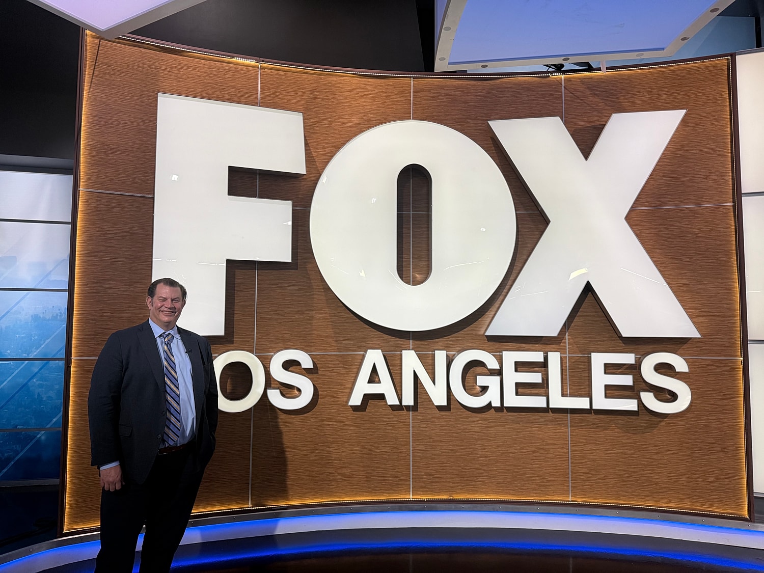 Person smiling by Fox Los Angeles sign