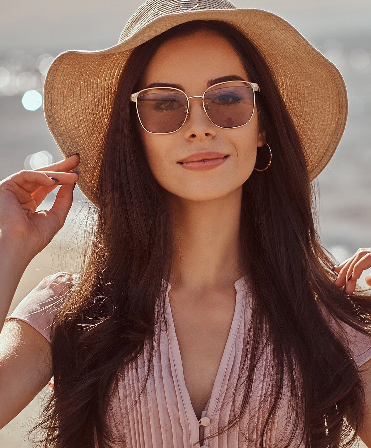 Woman with wavy hair and statement earrings.