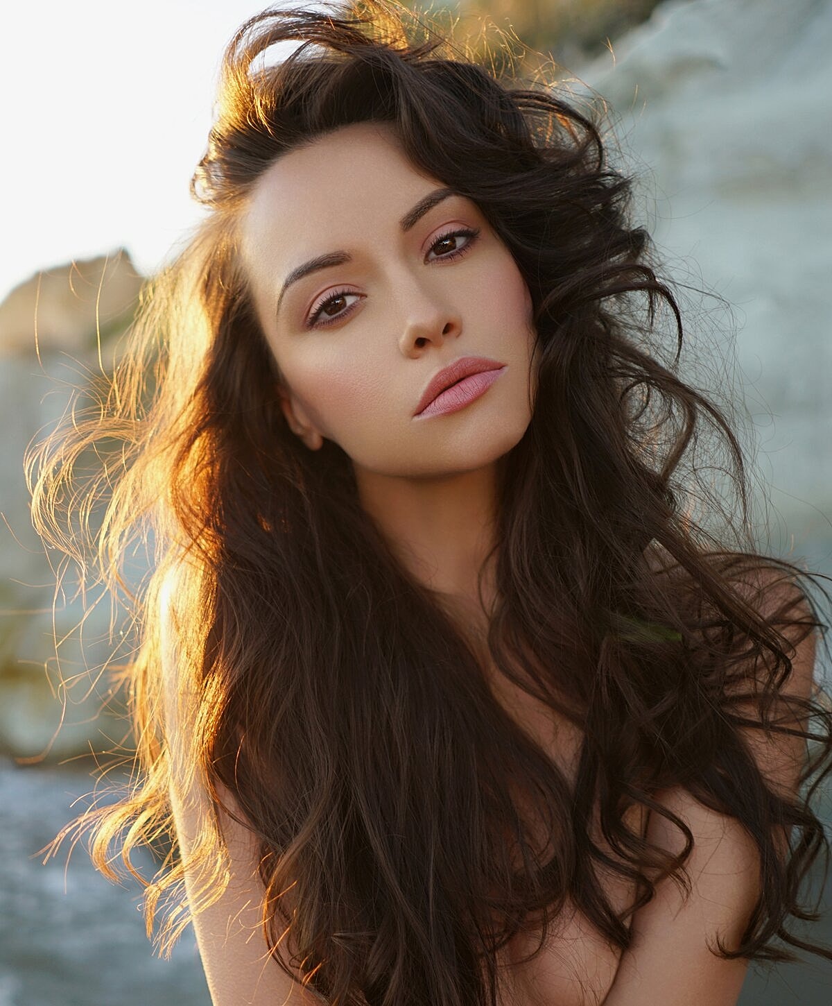 Portrait of a woman with long wavy hair.
