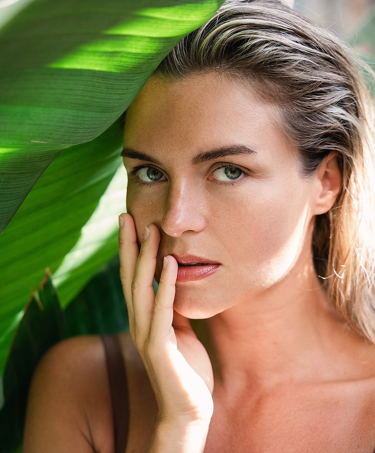 Woman with wavy hair and statement earrings.