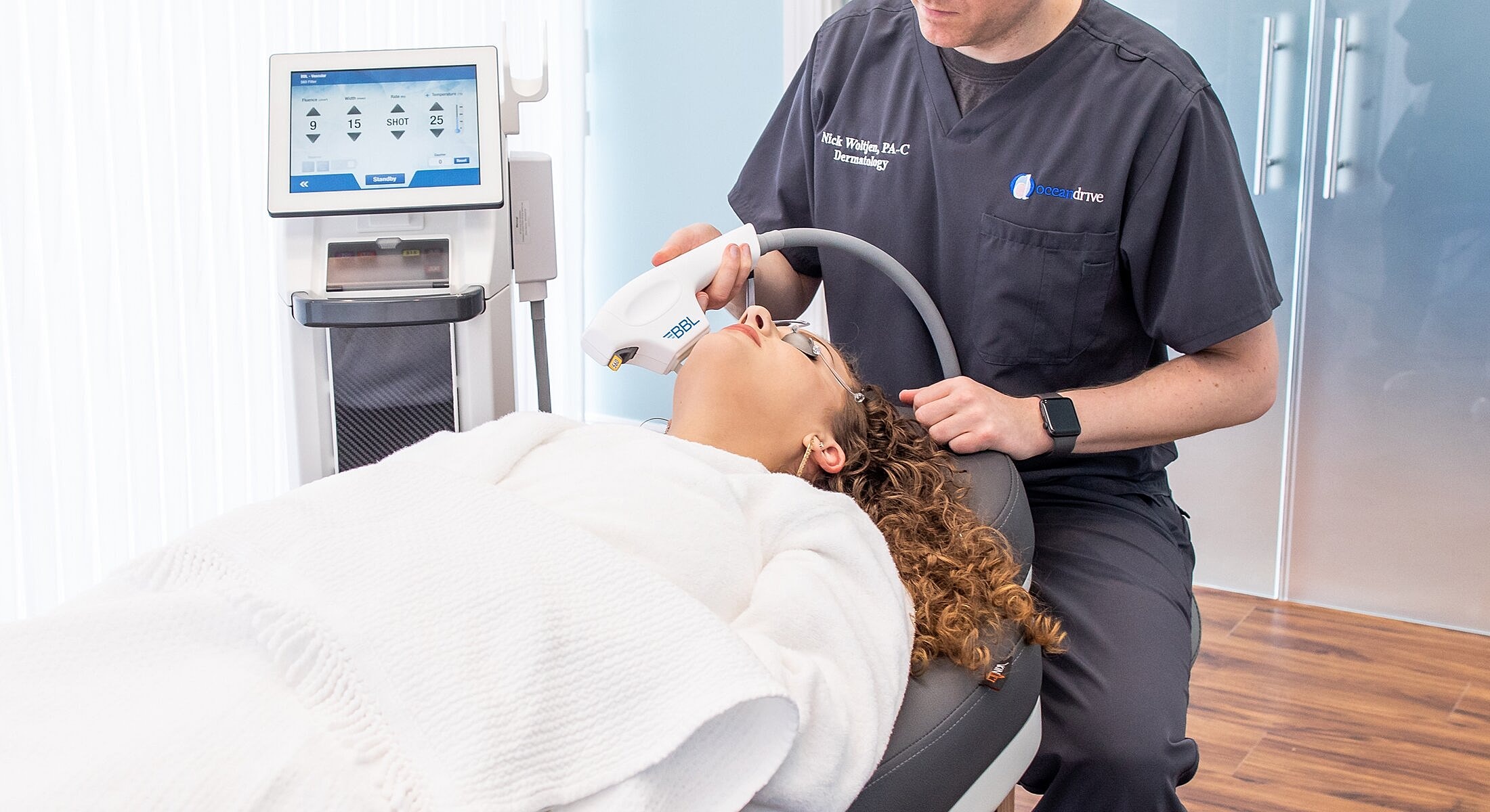Patient receiving laser treatment in a medical setting.
